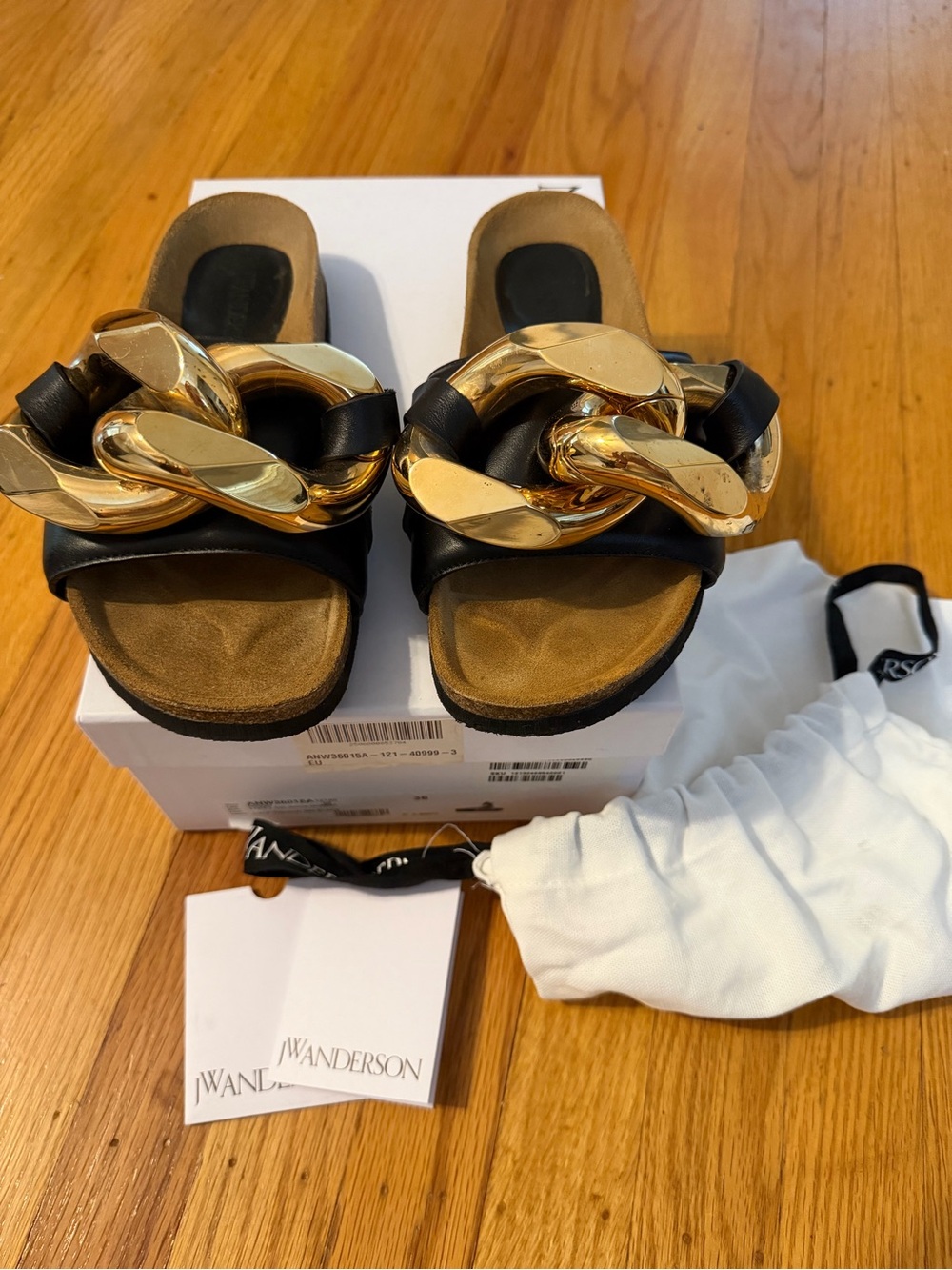 JW Anderson Women’s Black Slide Sandals with Gold Chain Accent